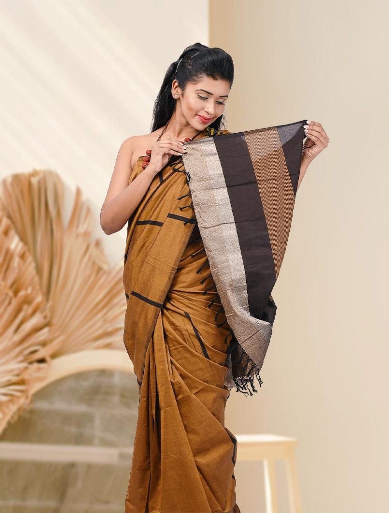 blackish brown glossy cotton saree with dark brown line design.